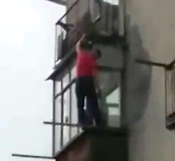 Drunk Russian Falls to the Ground While Climbing Outside the Building
