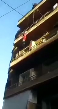 Girl Dangling from Building Ends up Falling,  Landing on Top of a man 
