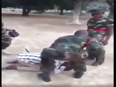 Drunk man repeatedly slapped by Nigerian soldiers.