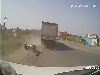 Woman on motorcycle crushed via a truck.