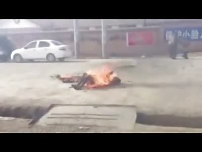 Mother and Son walk By as Monk Self Immolates to Death