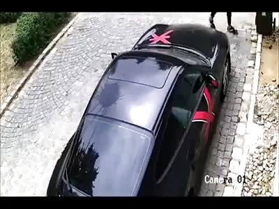 Guy Vandalises Porsche Using A Rock.